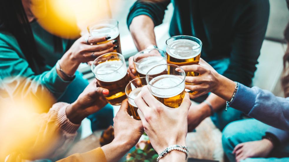 People clinking glasses of beer